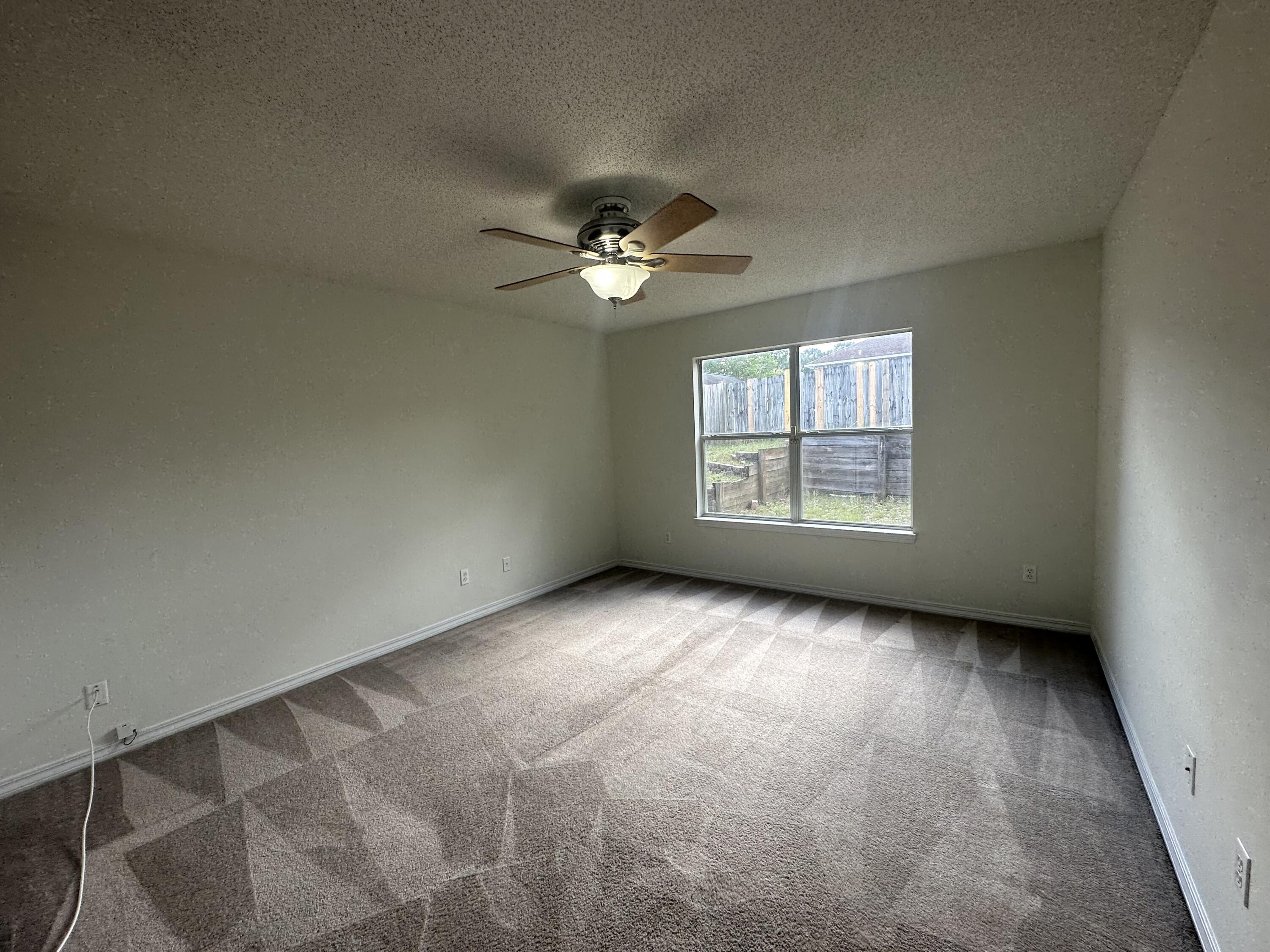 136 Sandstone Trail Crestview, FL 32539 - Photo 8 of 17 an empty room with windows and ceiling fan