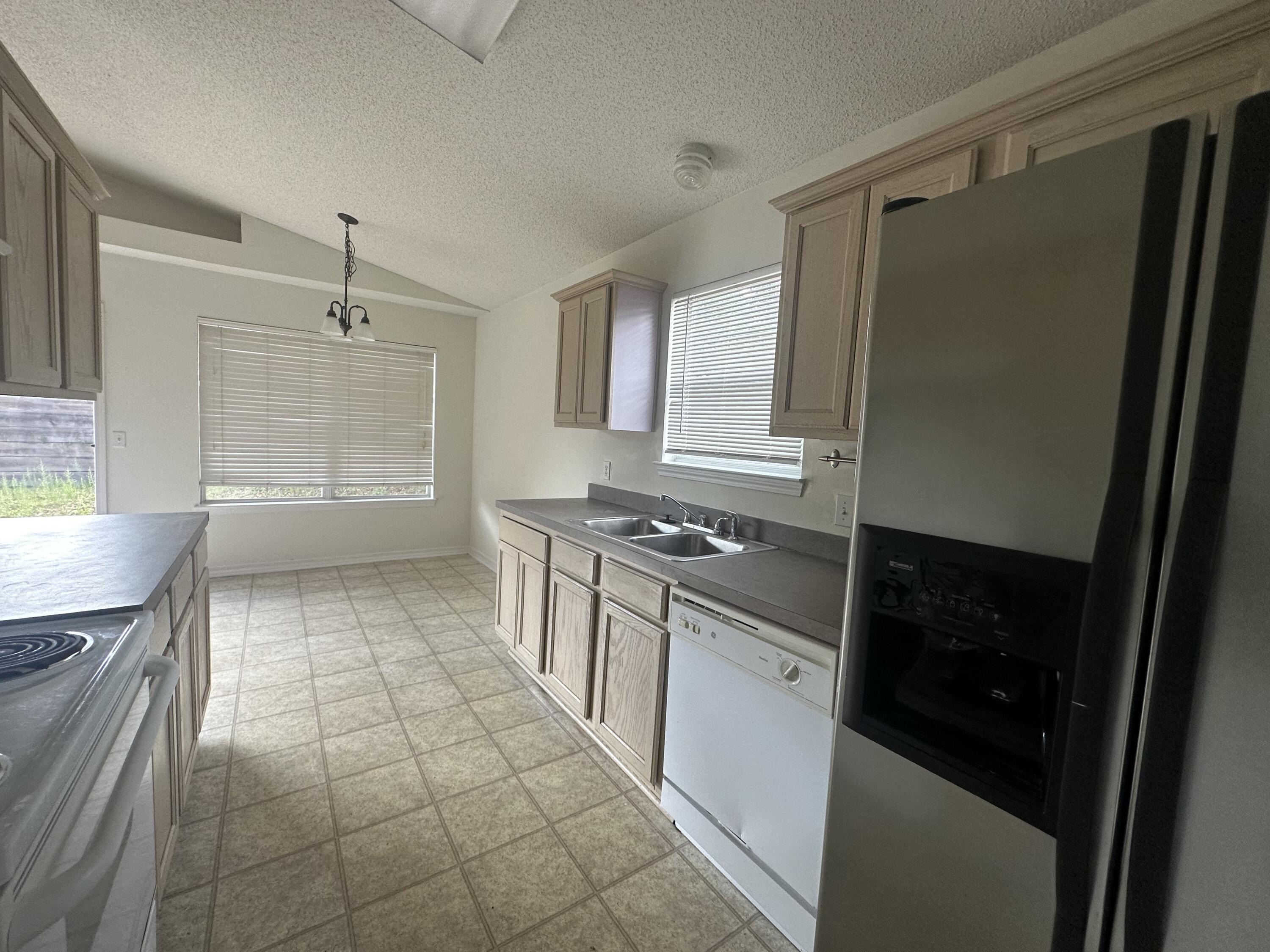136 Sandstone Trail Crestview, FL 32539 - Photo 9 of 17 a kitchen with stainless steel appliances granite countertop a refrigerator and a sink