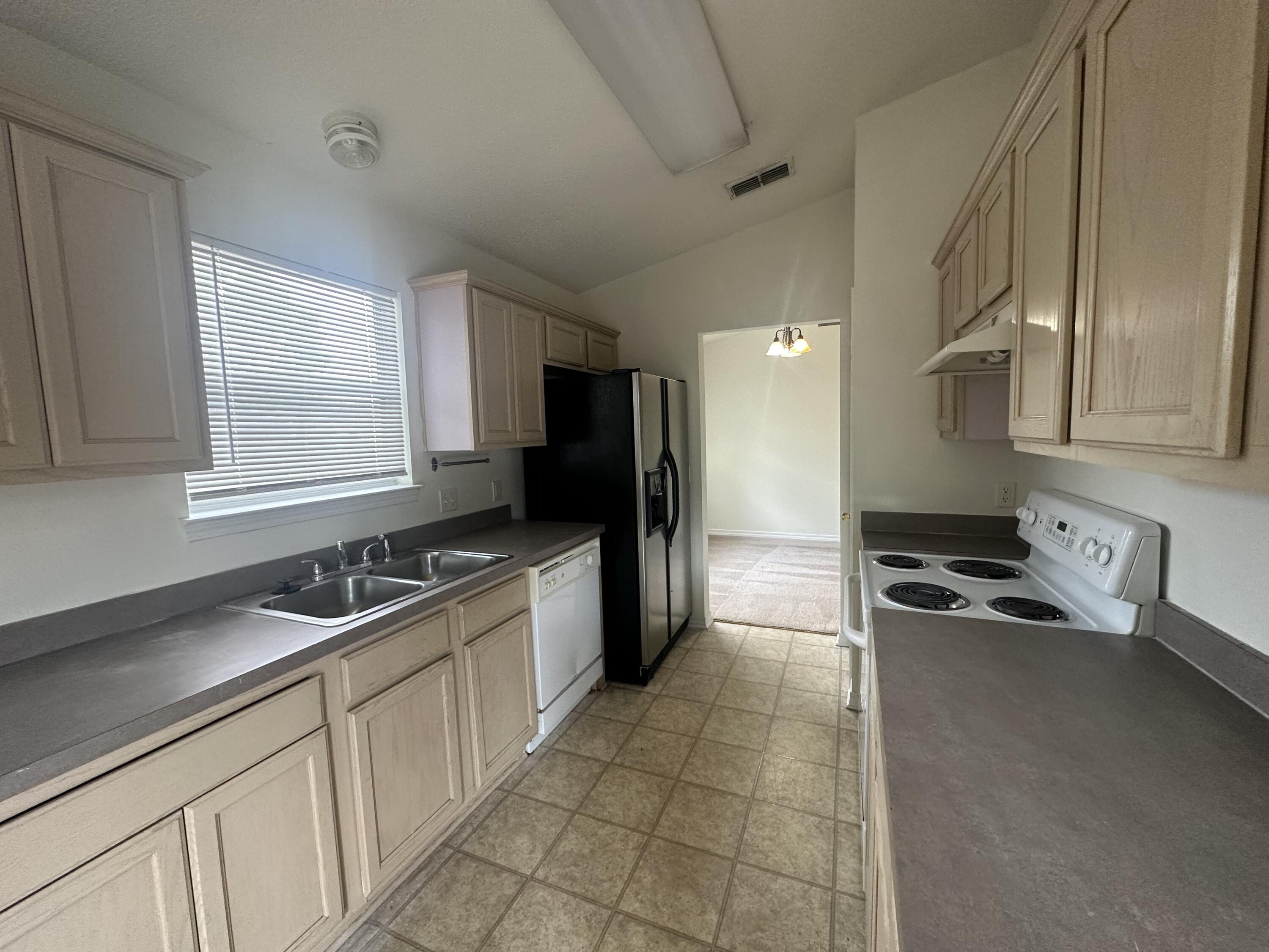 136 Sandstone Trail Crestview, FL 32539 - Photo 10 of 17 a kitchen with a sink stove top oven and refrigerator