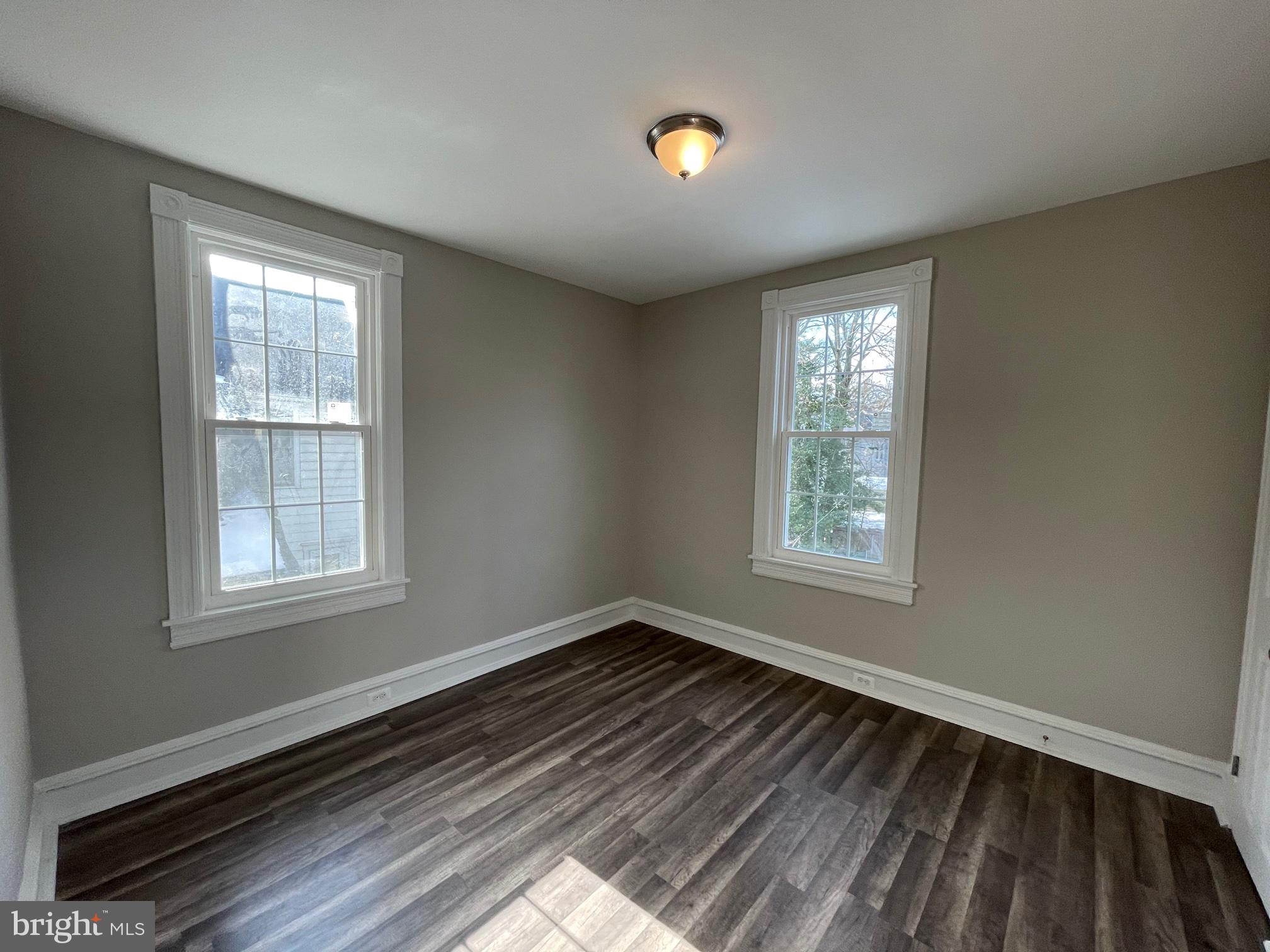 10 Clifton Avenue, Unit B Merchantville, NJ 08109 - Photo 11 of 20 a view of an empty room with wooden floor and a window