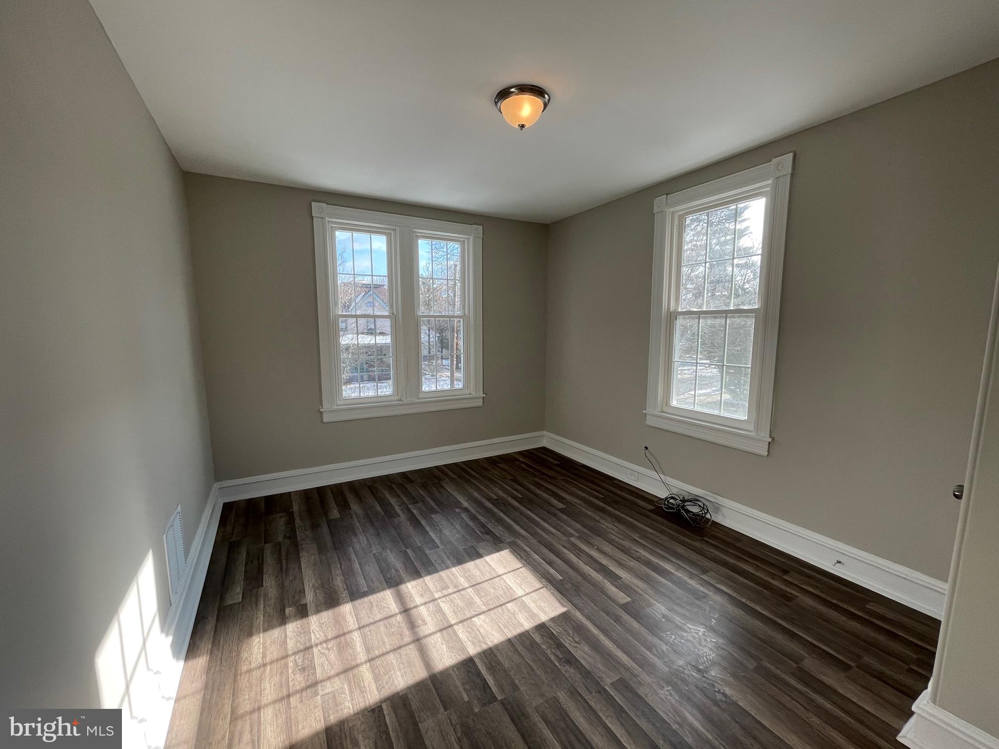 10 Clifton Avenue, Unit B Merchantville, NJ 08109 - Photo 12 of 20 wooden floor in an empty room with a window