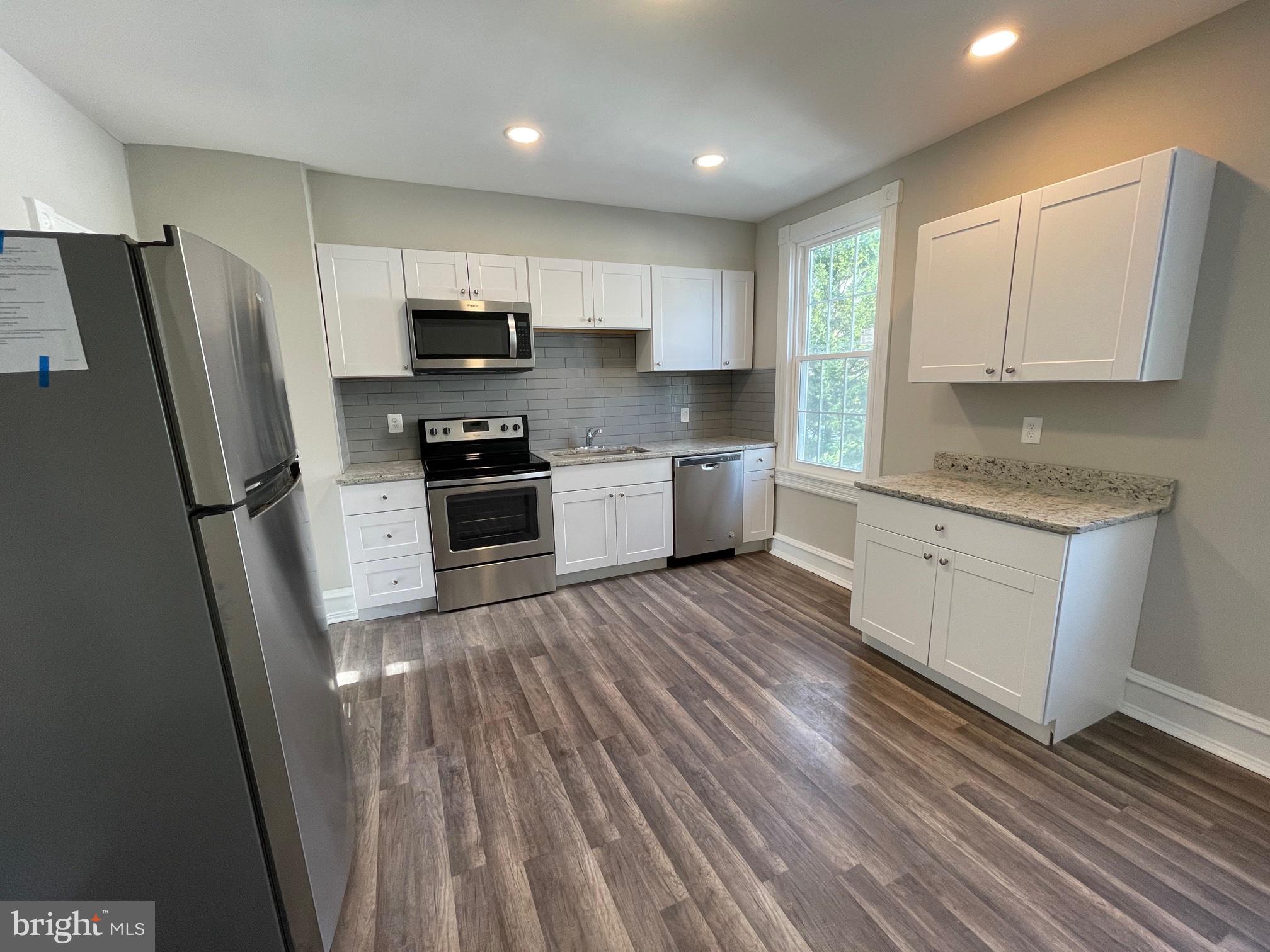 10 Clifton Avenue, Unit B Merchantville, NJ 08109 - Photo 5 of 20 a kitchen with stainless steel appliances a refrigerator sink and microwave