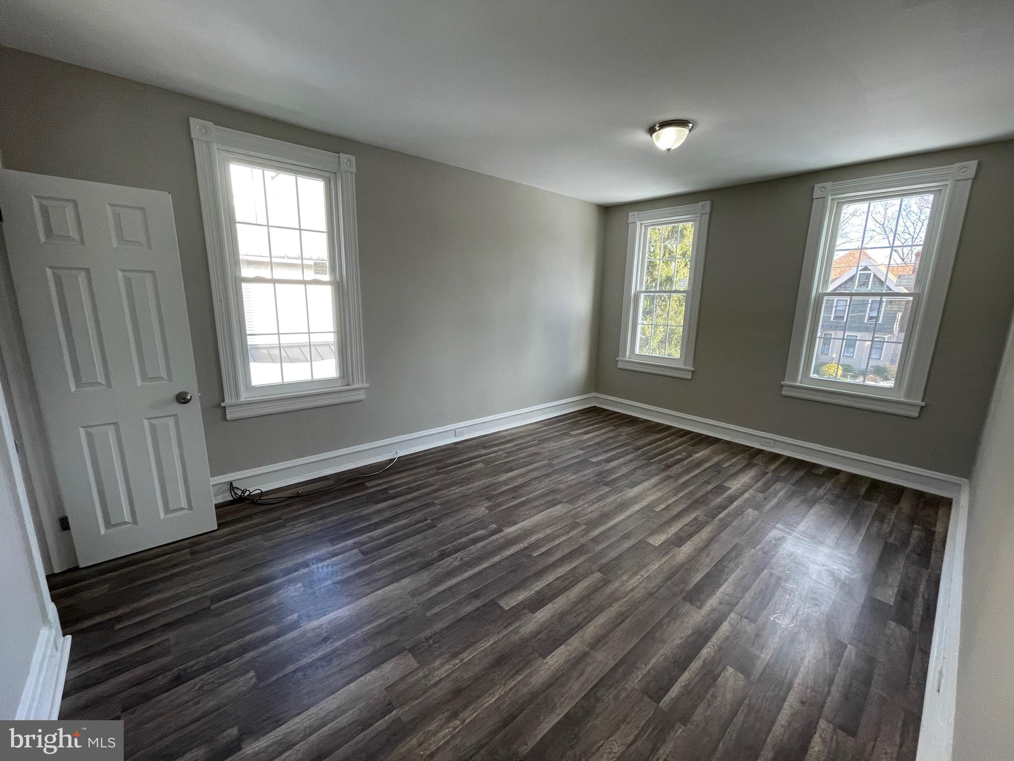 10 Clifton Avenue, Unit B Merchantville, NJ 08109 - Photo 9 of 20 a view of an empty room with wooden floor and a window