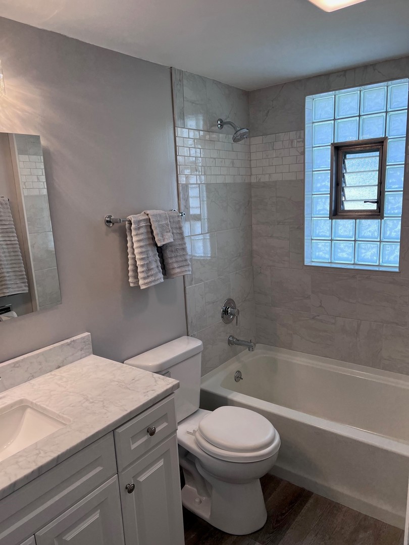 184 Waubansee Road Riverside, IL 60546 - Photo 11 of 38 a bathroom with a granite countertop toilet a sink and bathtub