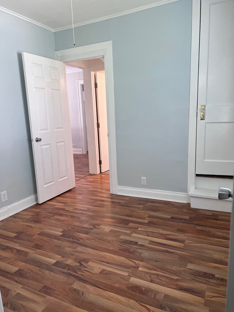 184 Waubansee Road Riverside, IL 60546 - Photo 13 of 38 a view of a room with wooden floor and white walls