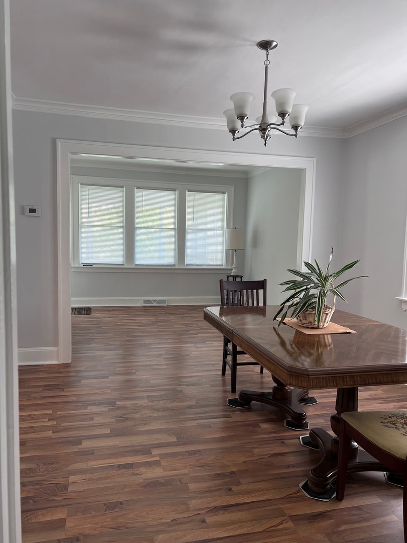 184 Waubansee Road Riverside, IL 60546 - Photo 19 of 38 a view of a room with furniture wooden floor and chandelier