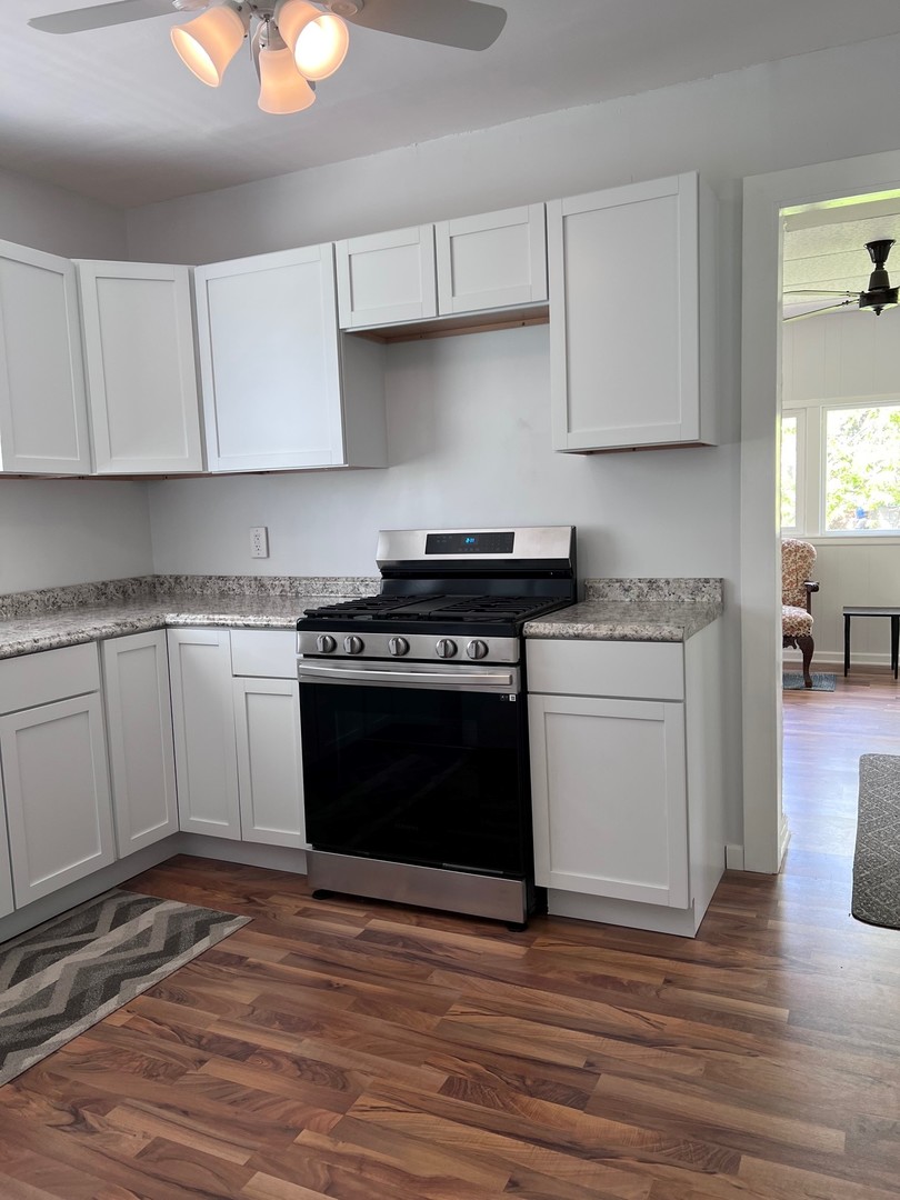 184 Waubansee Road Riverside, IL 60546 - Photo 20 of 38 a kitchen with a stove top oven and cabinets