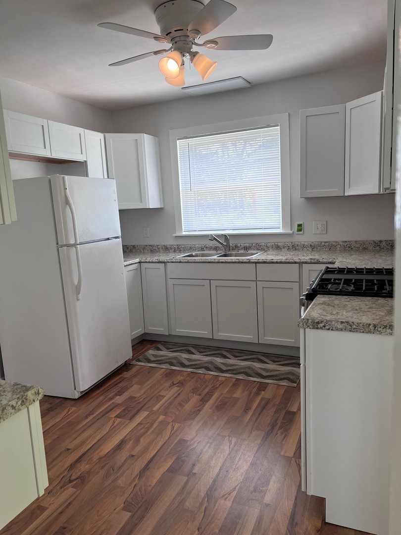 184 Waubansee Road Riverside, IL 60546 - Photo 27 of 38 a kitchen with granite countertop a refrigerator and a stove top oven