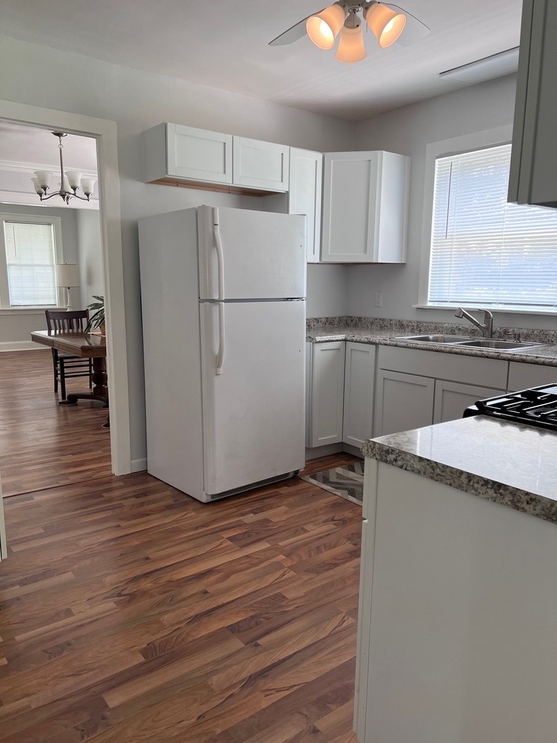 184 Waubansee Road Riverside, IL 60546 - Photo 35 of 38 a kitchen with granite countertop a refrigerator and a stove top oven
