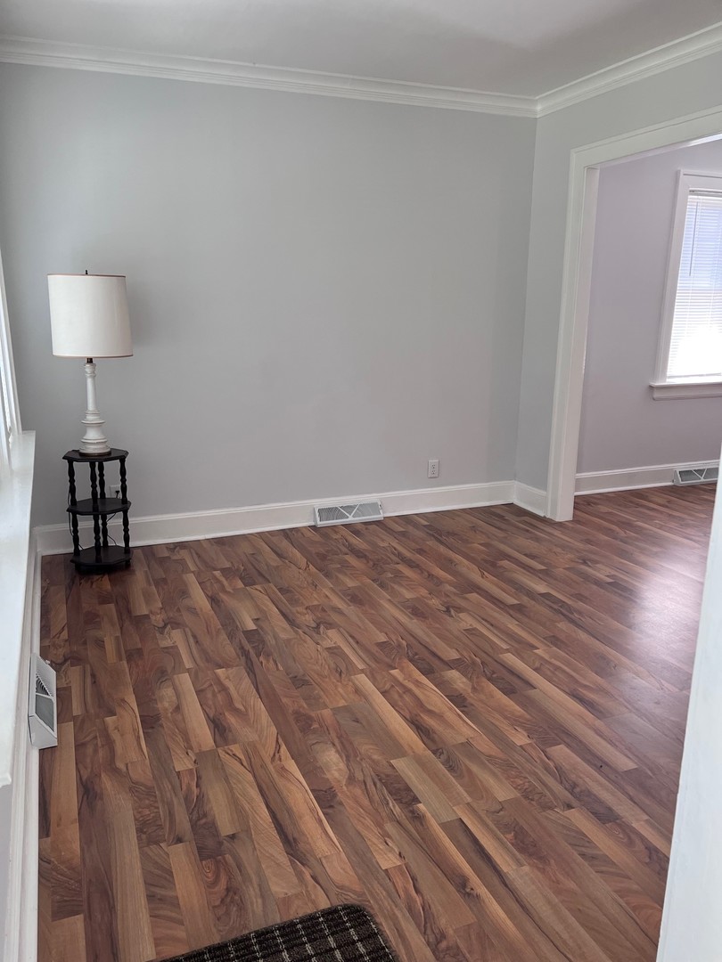 184 Waubansee Road Riverside, IL 60546 - Photo 5 of 38 a view of empty room with wooden floor and fan