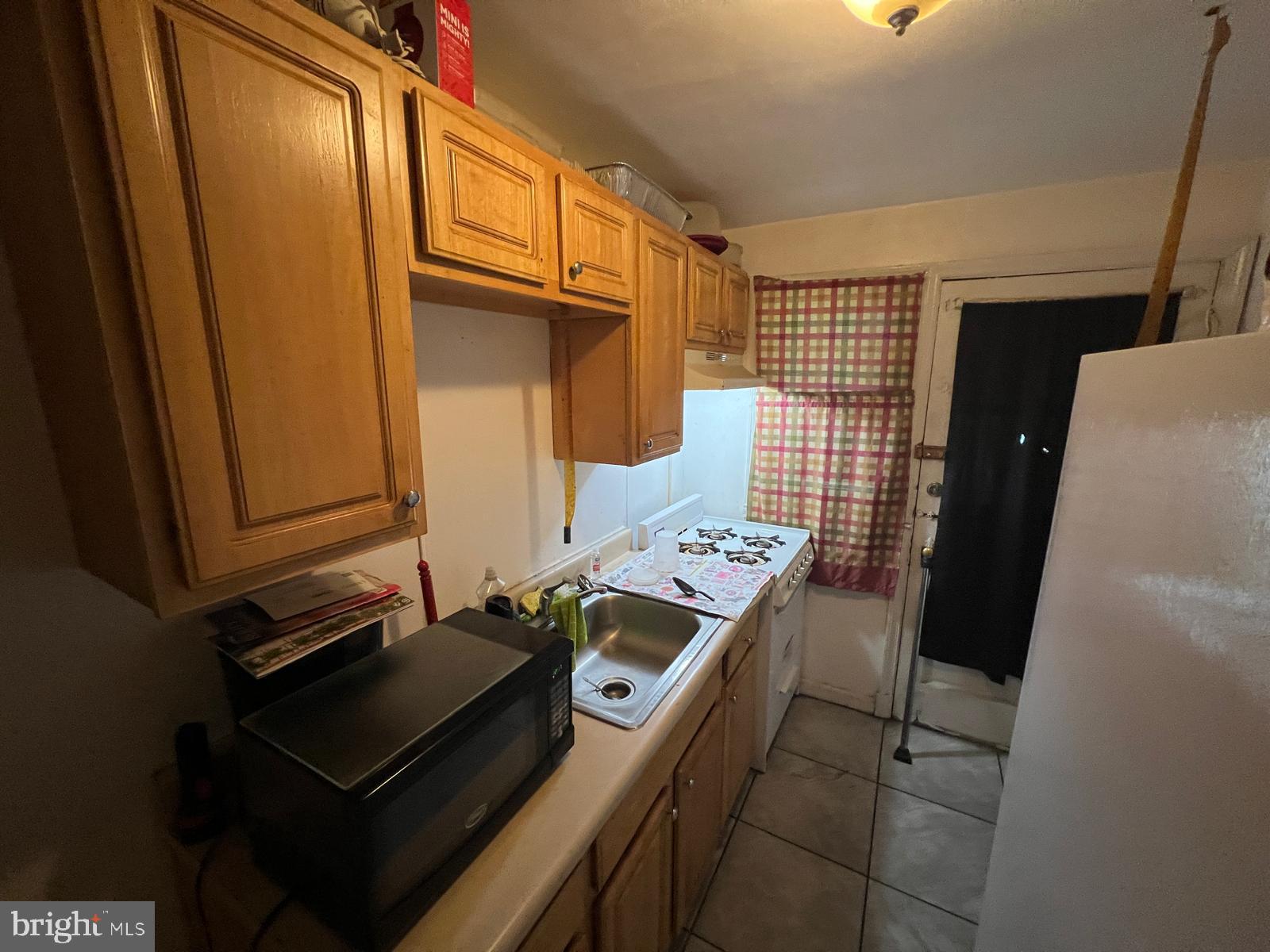 3917 Dudley Avenue Baltimore, MD 21213 - Photo 27 of 65 a bathroom with a sink a mirror and shower