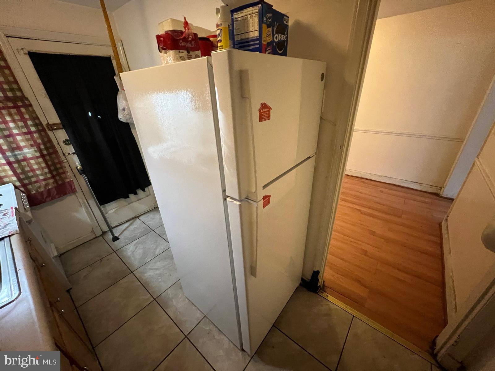 3917 Dudley Avenue Baltimore, MD 21213 - Photo 28 of 65 a white refrigerator freezer sitting inside of a kitchen