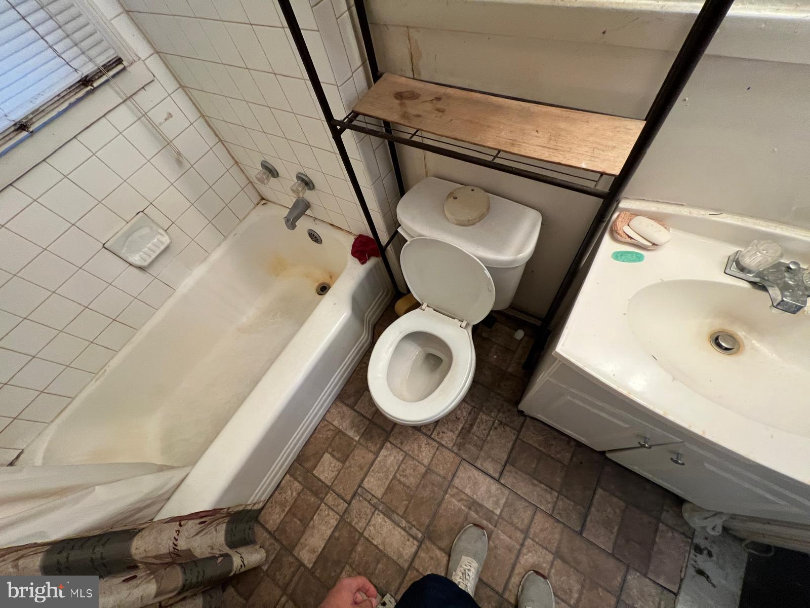 3917 Dudley Avenue Baltimore, MD 21213 - Photo 3 of 65 a bathroom with a sink mirror vanity and toilet