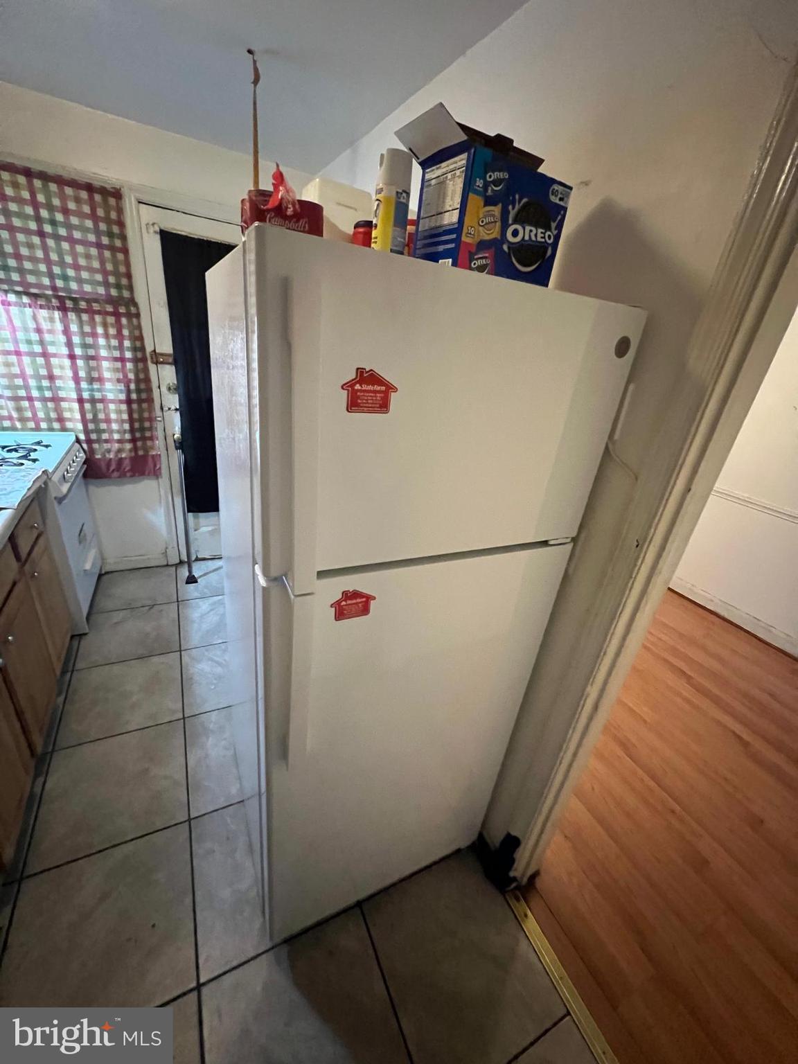 3917 Dudley Avenue Baltimore, MD 21213 - Photo 33 of 65 a view of a refrigerator in kitchen and an empty room