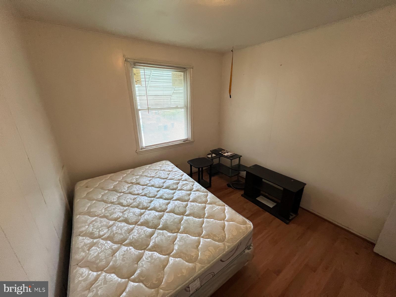 3917 Dudley Avenue Baltimore, MD 21213 - Photo 62 of 65 a bed sitting in a bedroom next to a window