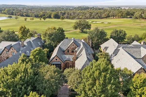 an aerial view of a house with outdoor space and lake view