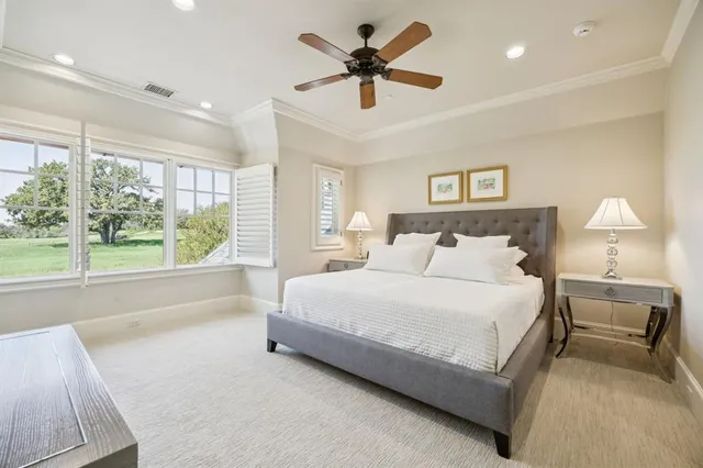 a spacious bedroom with a bed and a large window