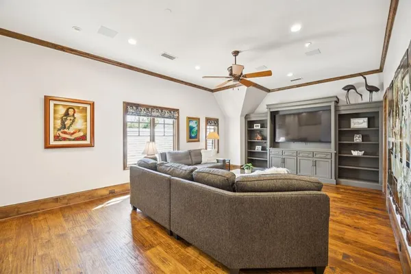 a living room with furniture wooden floor and window