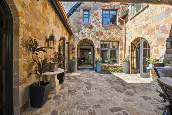 a view of front door of house with outdoor seating