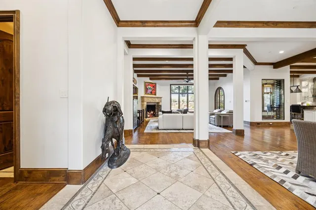 a view of a livingroom with wooden floor and a rug