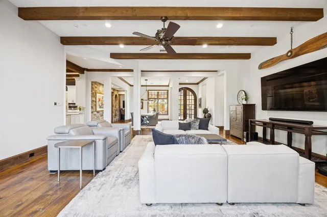 a living room with a bed a flat screen tv and couches