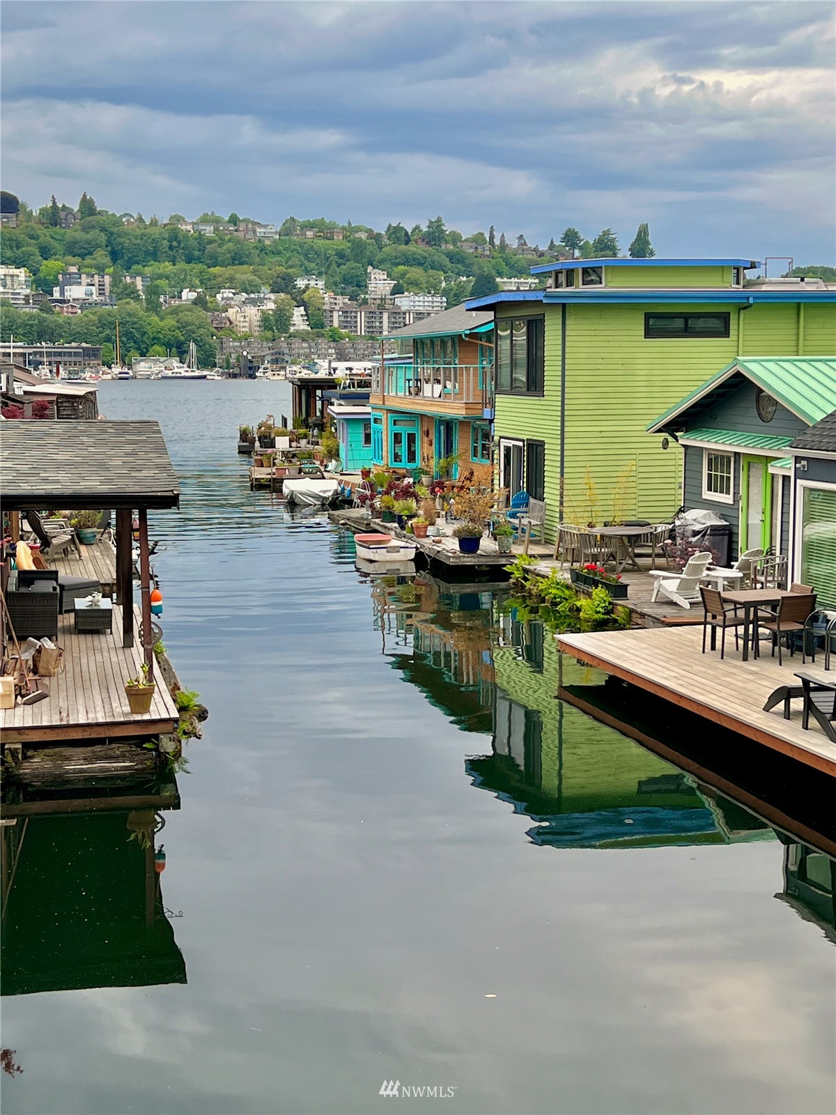 2019 Fairview Avenue East, Unit R Seattle, WA 98102 - Photo 18 of 23 a view of a patio with lawn chairs wooden floor and city view