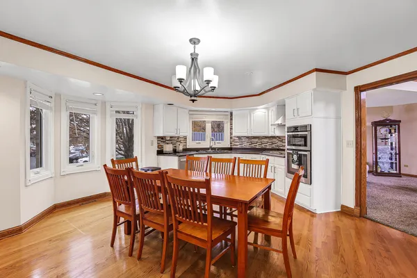 a view of a dining room with furniture and wooden floor