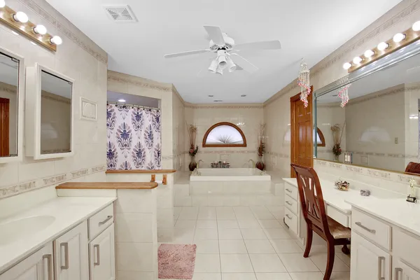 a spacious bathroom with a sink a mirror and a bathtub