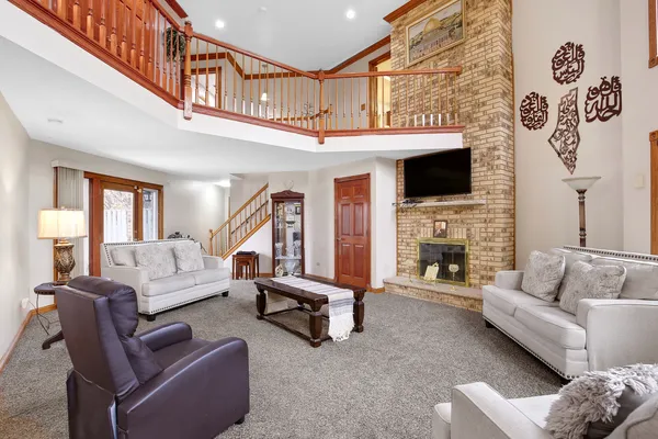 a living room with furniture a fireplace and a flat screen tv