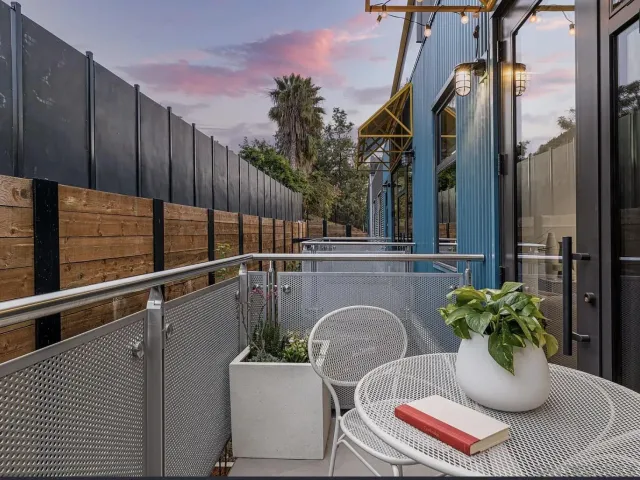 a balcony with table and chairs