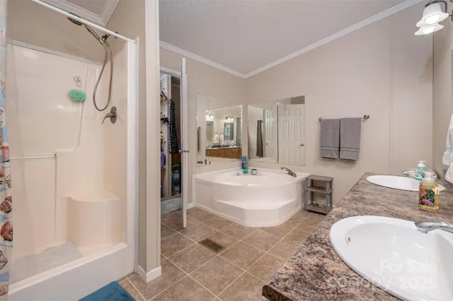 a bathroom with a tub sink and mirror