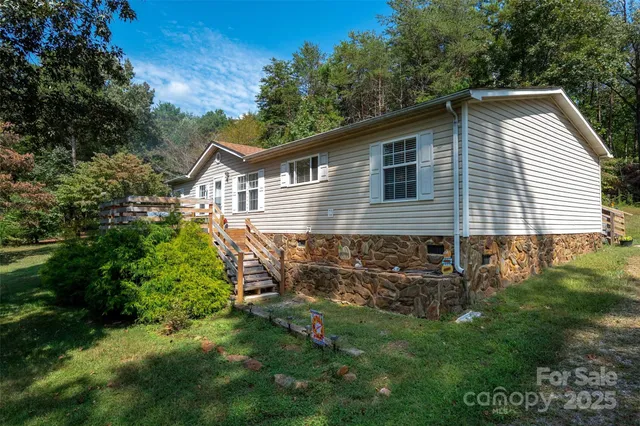 a view of backyard of house with green space