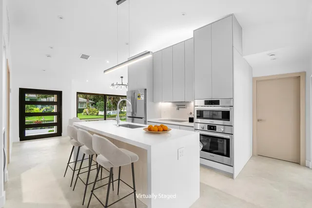 a kitchen with stainless steel appliances a stove a sink and a refrigerator