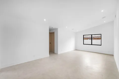 a view of a livingroom with furniture and kitchen view