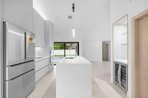 a kitchen with a refrigerator and a sink