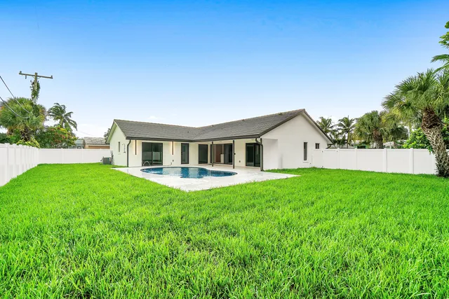 a view of a swimming pool with a yard