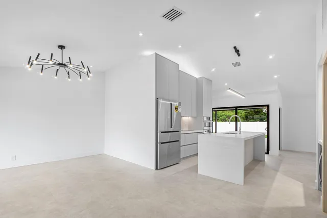 a kitchen with a refrigerator and a sink