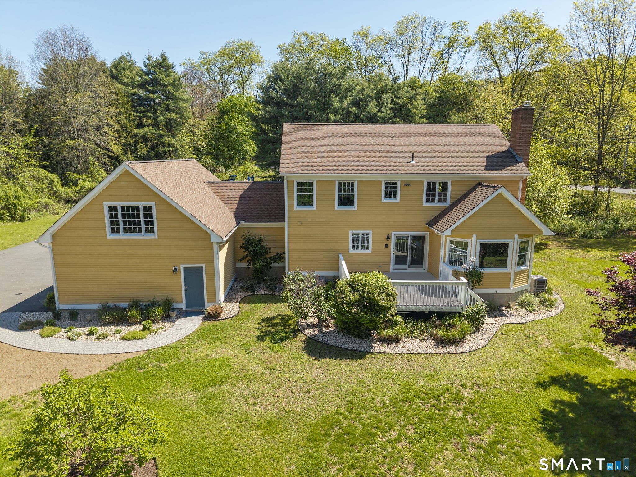 555 Waterville Road Avon, CT 06001 - Photo 3 of 40 a aerial view of a house with a yard and potted plants