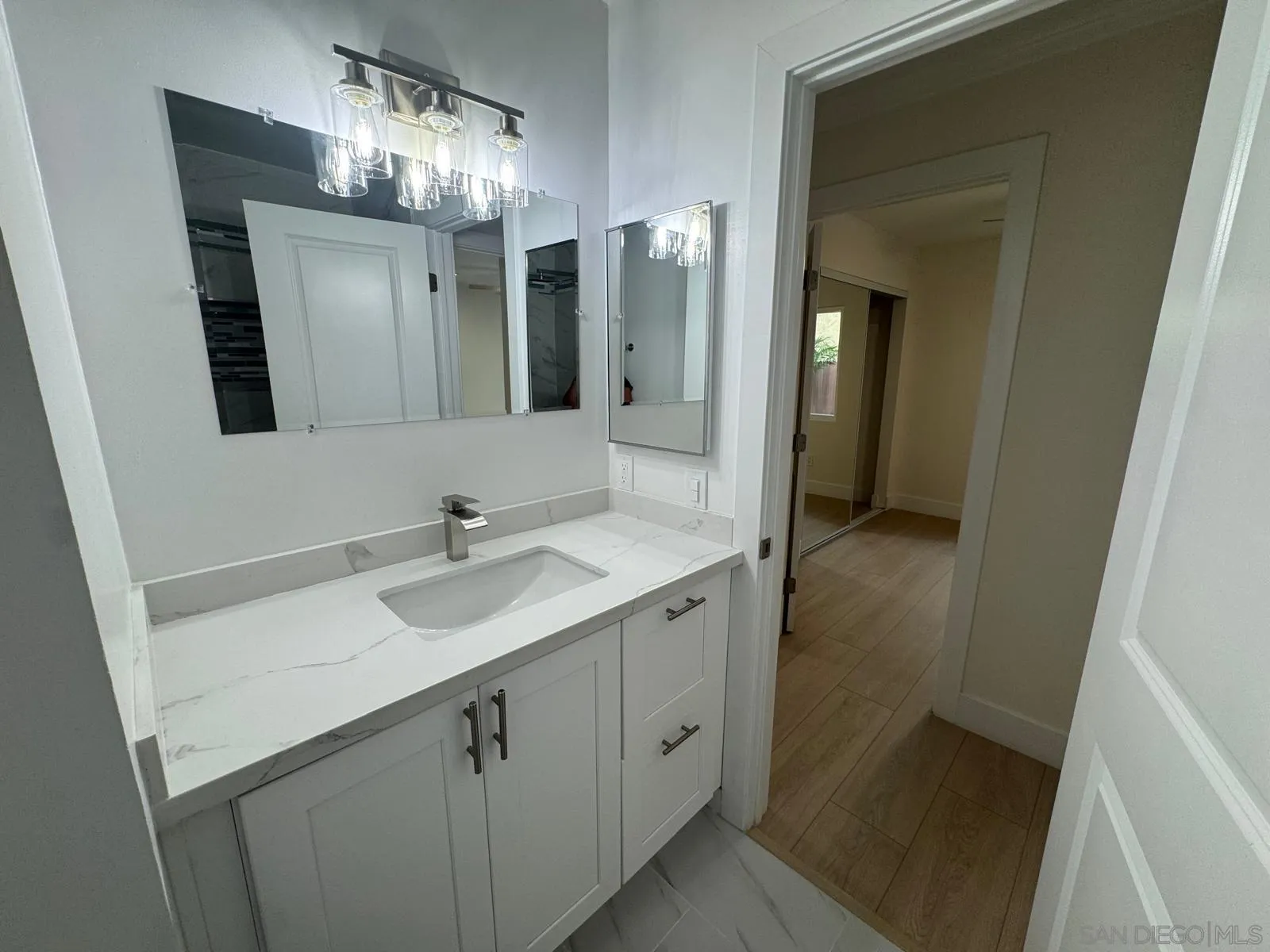 1205 27th Street San Diego, CA 92154 - Photo 11 of 25 a bathroom with a sink and a mirror
