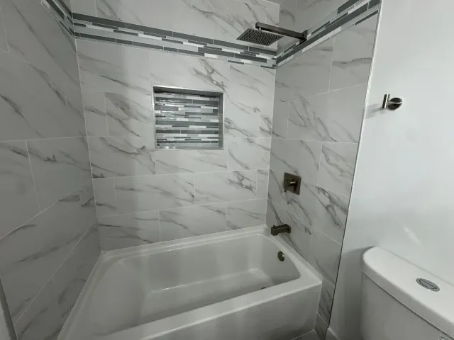a bathroom with a bathtub and a shower