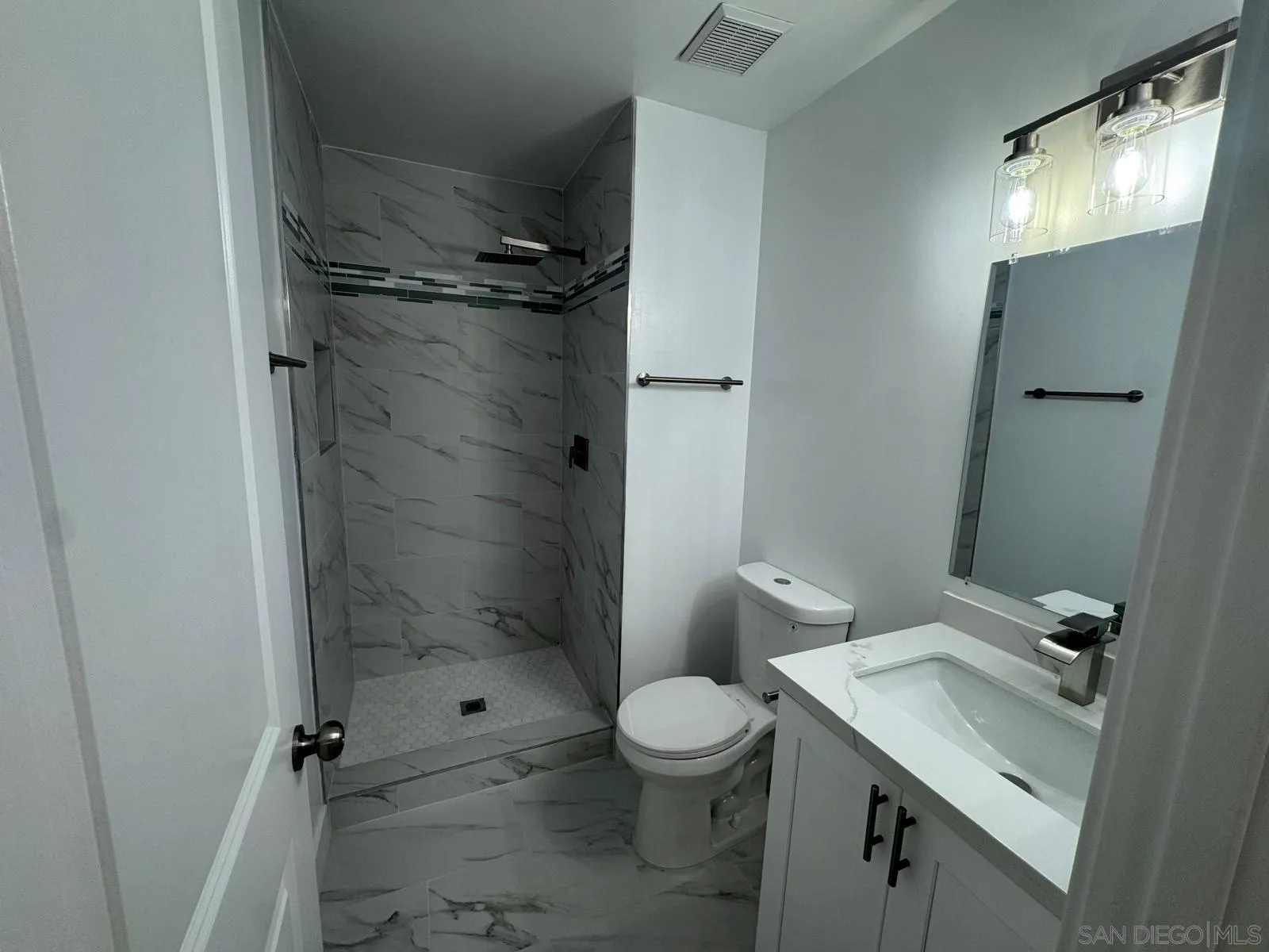 1205 27th Street San Diego, CA 92154 - Photo 14 of 25 a bathroom with a sink toilet and shower