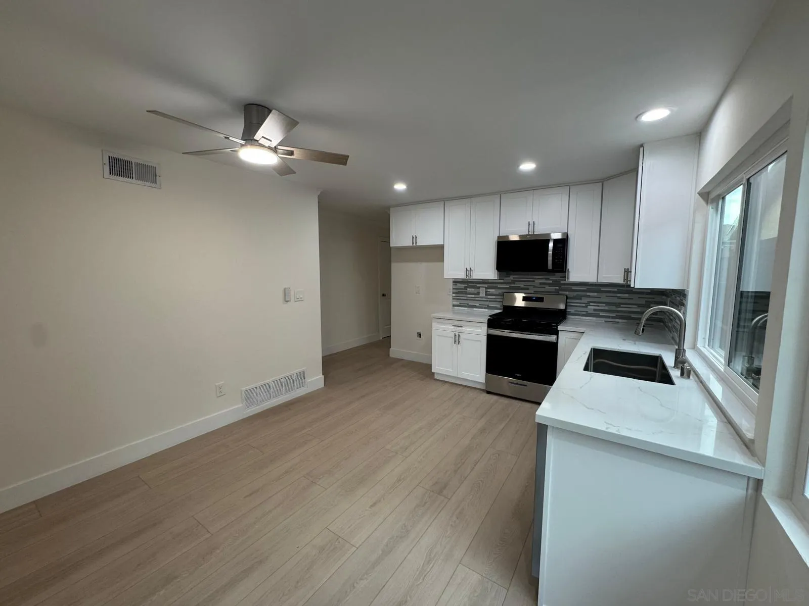 1205 27th Street San Diego, CA 92154 - Photo 2 of 25 a kitchen with a refrigerator a stove top oven a sink and dishwasher