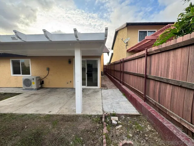 a view of a house with wooden fence