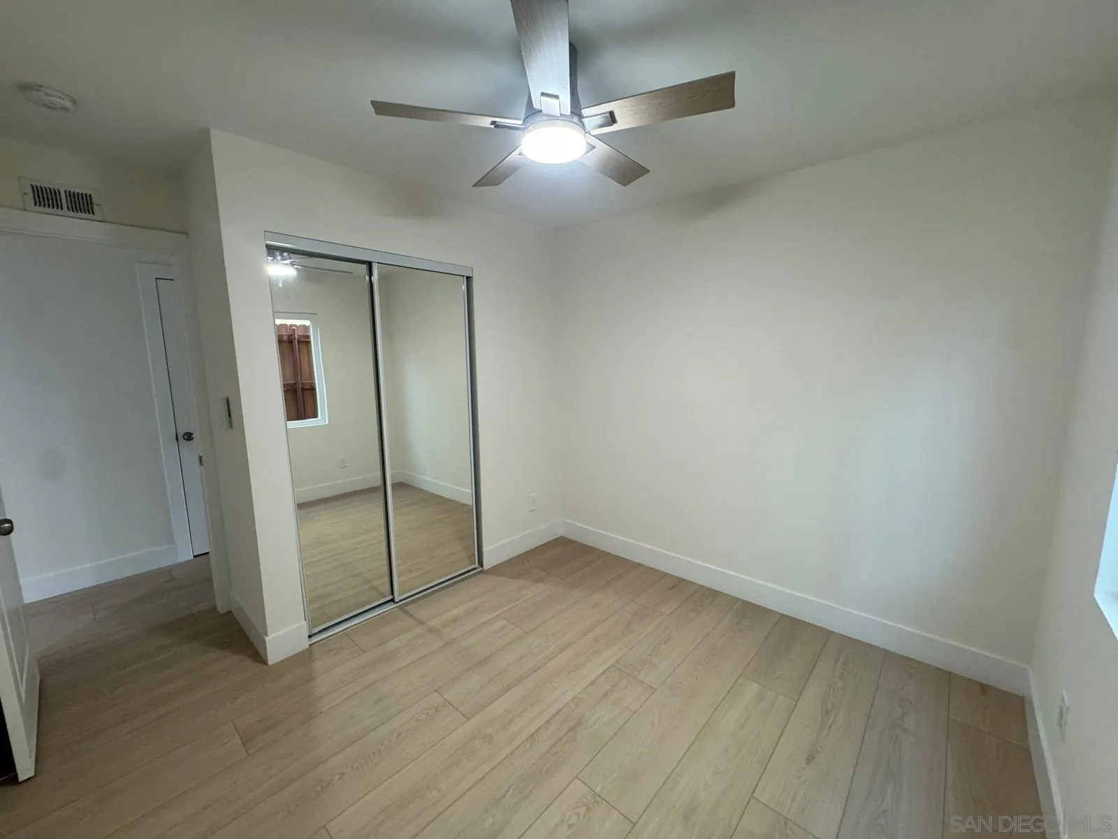 1205 27th Street San Diego, CA 92154 - Photo 7 of 25 an empty room with fan and entrance