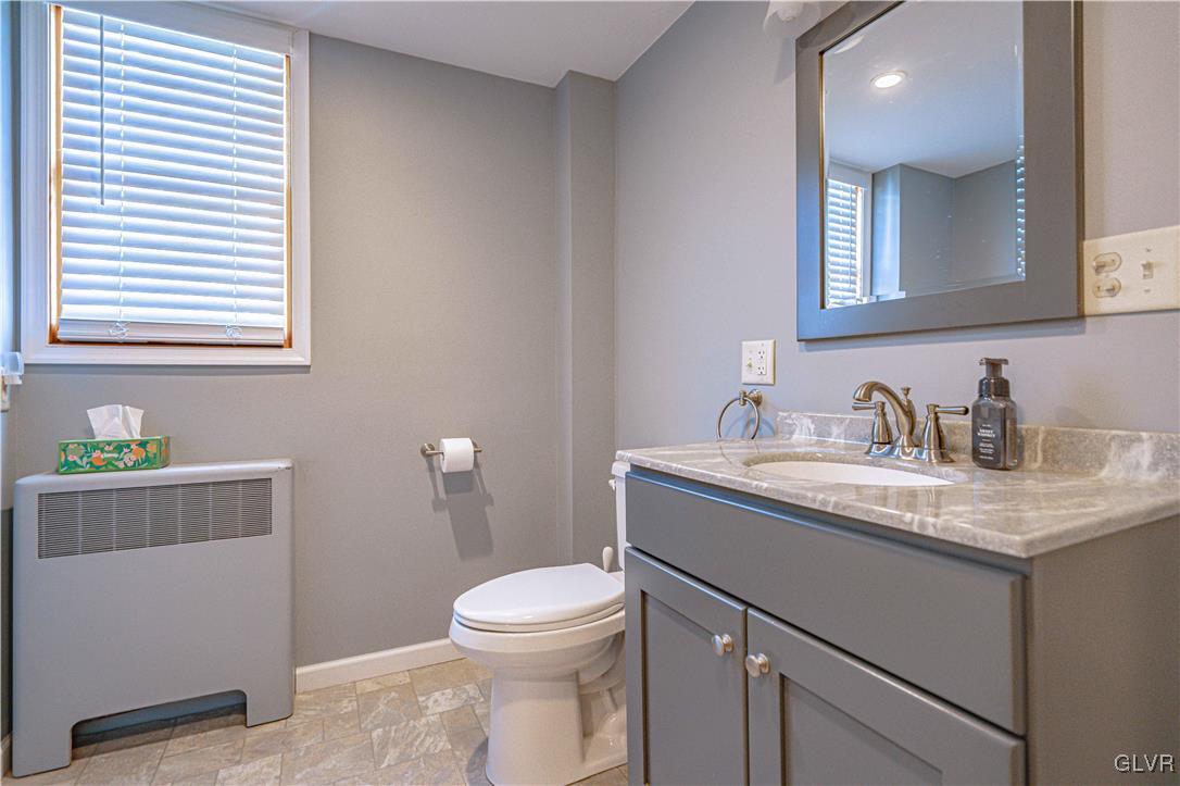 111 Maple Street Coplay, PA 18037 - Photo 14 of 38 a bathroom with a granite countertop sink toilet and mirror
