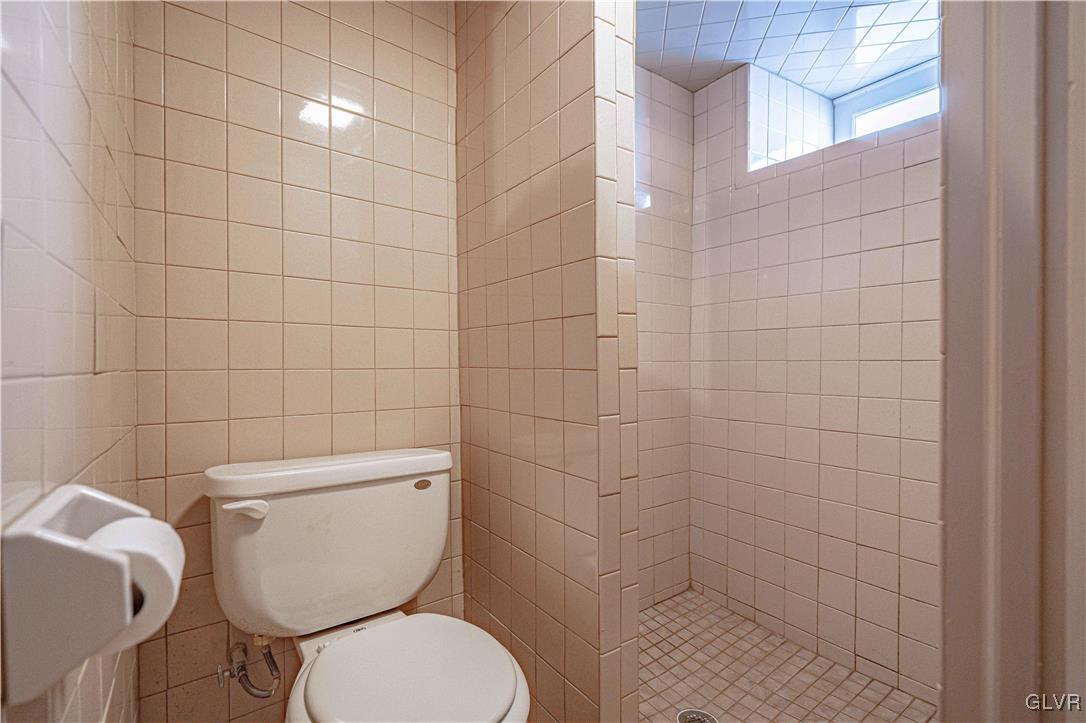 111 Maple Street Coplay, PA 18037 - Photo 30 of 38 a white toilet sitting next to a bathroom sink