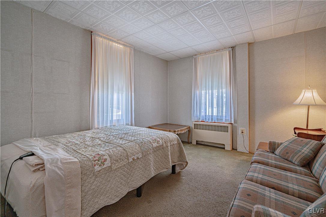 111 Maple Street Coplay, PA 18037 - Photo 7 of 38 a spacious bedroom with a bed and a couch