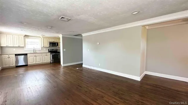 a view of a kitchen with a dishwasher and a refrigerator