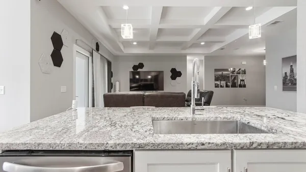 a kitchen with kitchen island a sink and a refrigerator