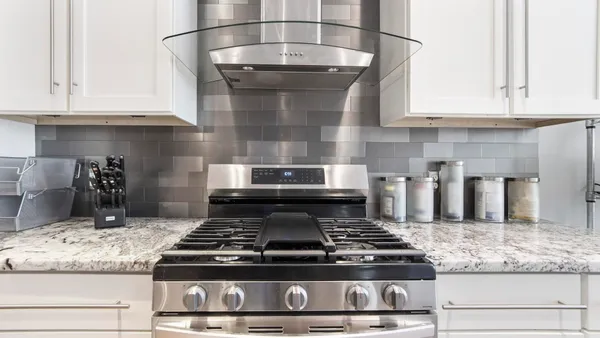 a stove top oven sitting inside of a kitchen